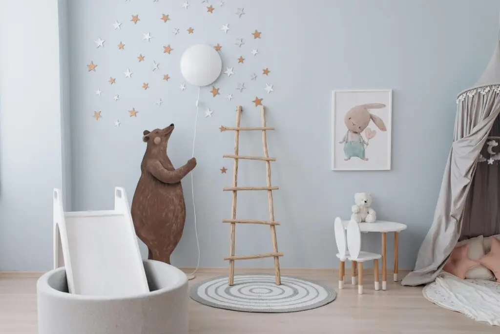A cozy nursery featuring bear and rabbit decor, wooden ladder, and star decorations for a dreamy setting.